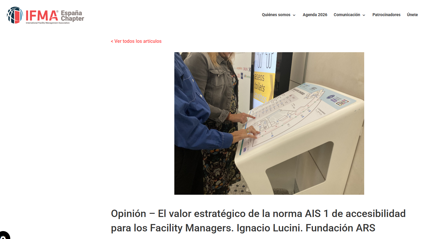 Dos personas consultan un plano táctil de un edificio en un panel accesible, diseñado para facilitar la orientación de personas con discapacidad visual.